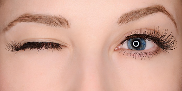 Woman's face with long dark eye lashes (MODEL)