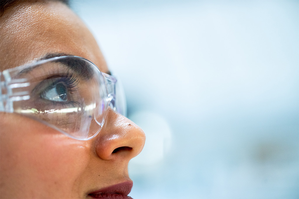 Female factory wearing eye protection to prevent eye injuries in the workplace