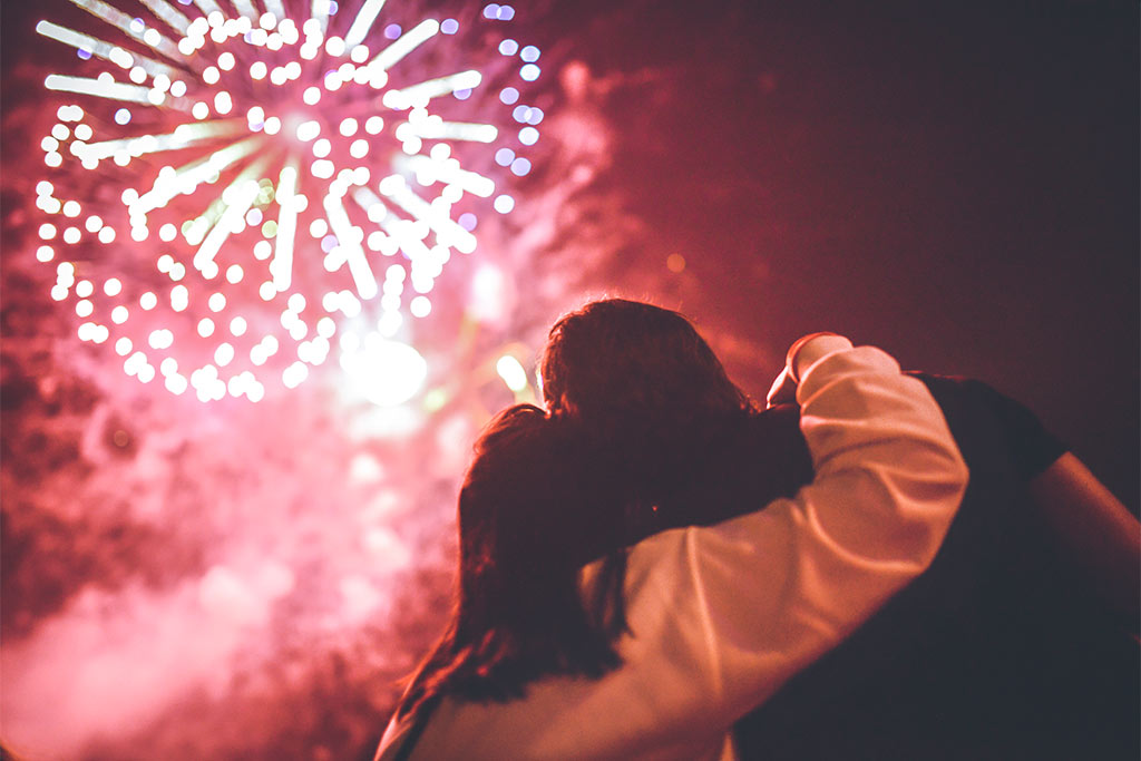 nJoy Vision Fireworks Eye Safety blog feature image of a couple safely observing a fireworks show from a safe distance