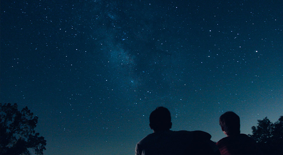 nJoy Vision Summertime is LASIK blog post story image of two people stargazing