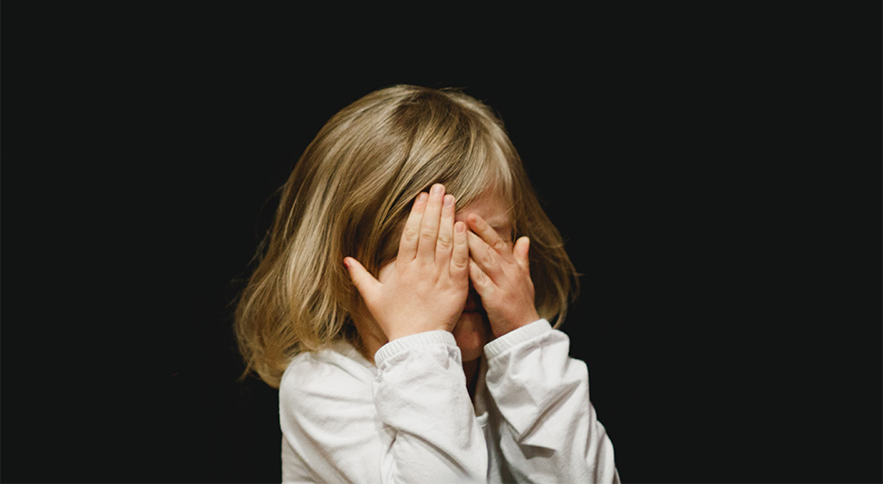 nJoy Vision Children's Eye Health and Safety Month blog post image of a young child covering their eyes