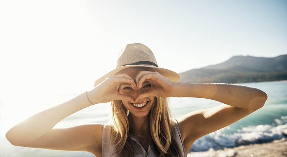 nJoy Vision LASIK alternatives blog post story image of young woman make a hand heart over her eyes