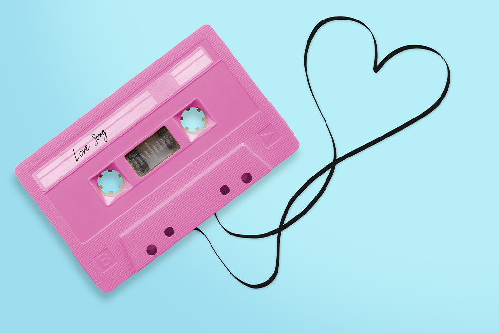 nJoy Vision Oklahoma City LASIK Blog Love LASIK Playlist feature image of a pink mixtape with unwound tape shaped like a heart on a light blue background